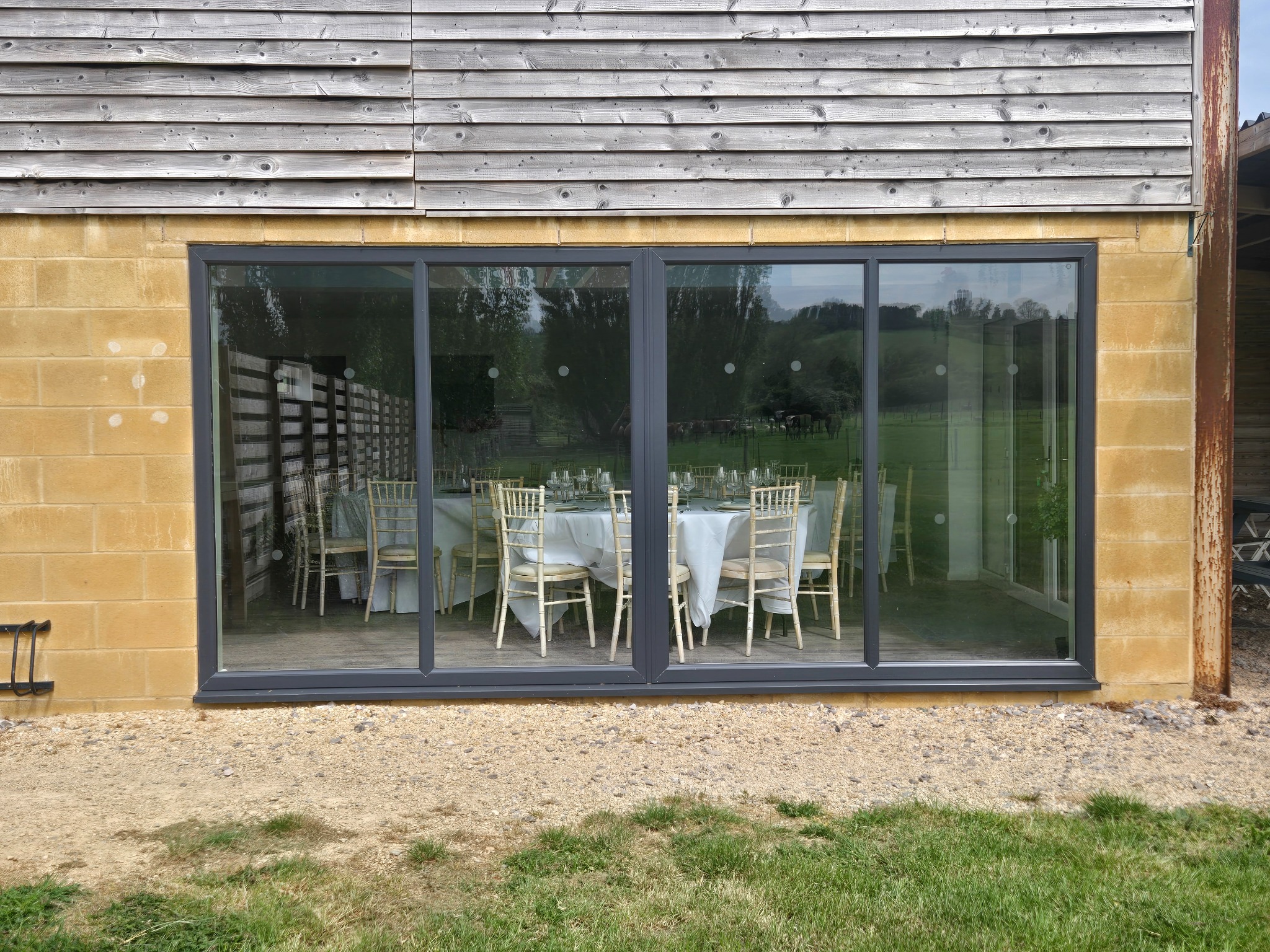 Large glass doors looking into the barn