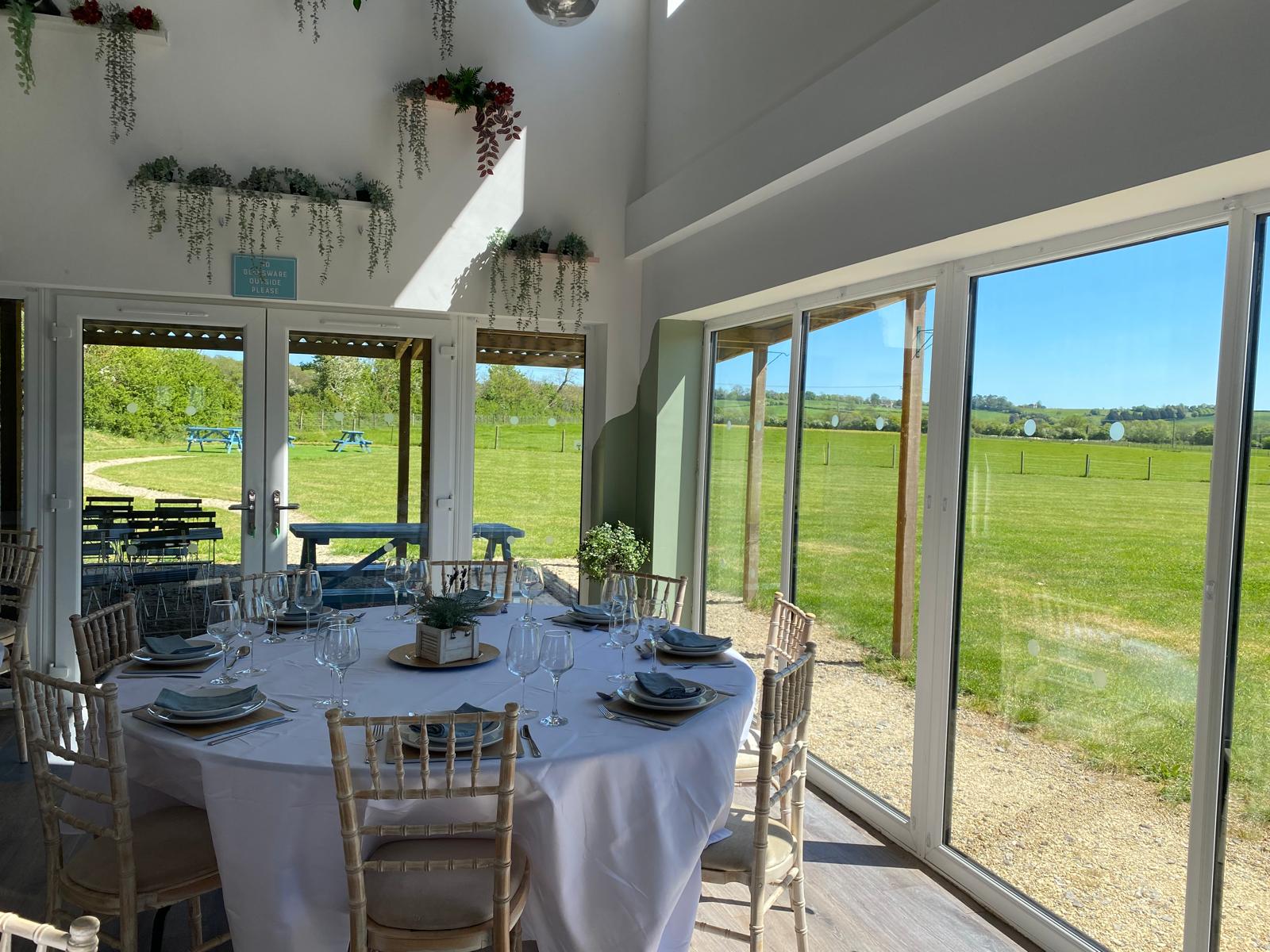 Round table setting inside The Barn at Stockham Marsh